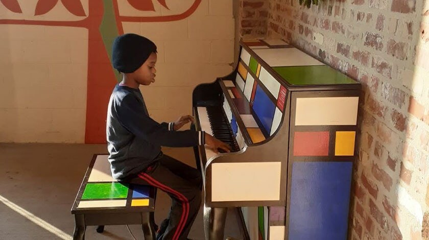 Musandela playing the piano