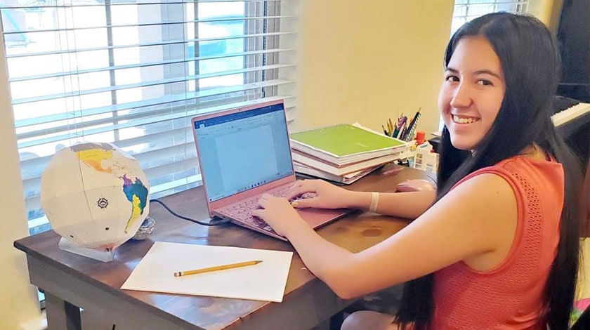 Sheridan at her desk attending online school