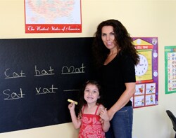 Marla and her daughter at a chalkboard