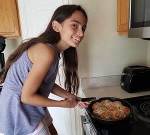 Charlotte baking cinnamon rolls