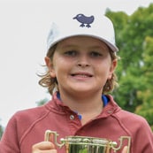 Image of Max holding a trophy