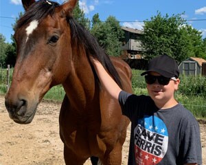 Wyatt petting a horse