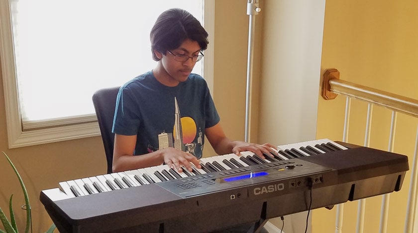 Abrar playing his electric keyboard