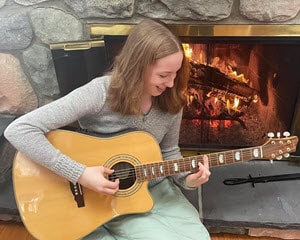 Christina S from Lighthouse Connecitons Academy plays the guitar