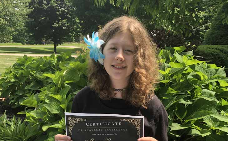 Megan P. with her Honor Roll Certificate from Lighthouse Connections Academy. 