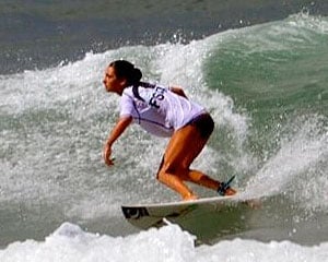 Maddie doing a bottom turn while surfing