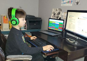 Allister at his desk attending Minnesota Connections Academy