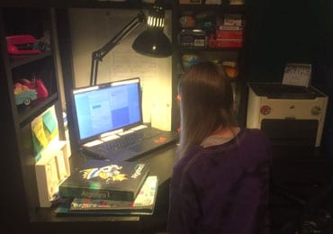 Shay at her desk attending online school