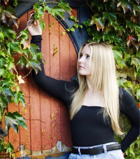 Shay posing by a door