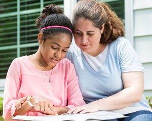 Malinda studying with her daughter