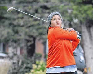 Caitlin hitting a golf ball