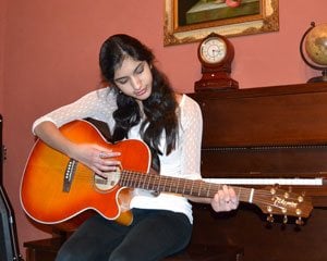 Nikhita playing the acoustic guitar