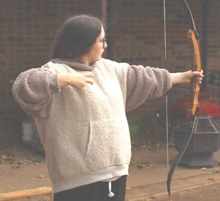 Lenore practicing archery