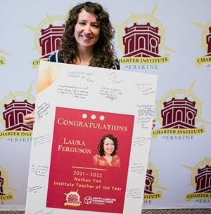 Image of Laura Ferguson holding a Teacher of the Year award
