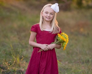 Image of Mary Kate holding yellow flowers