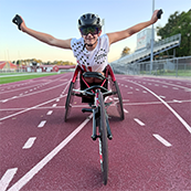 Ryan in his wheel chair with his arms raised