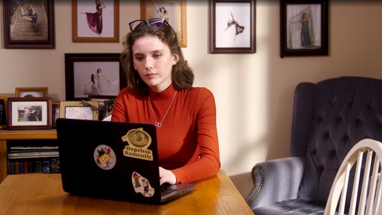 Online school student sitting at a table on their laptop