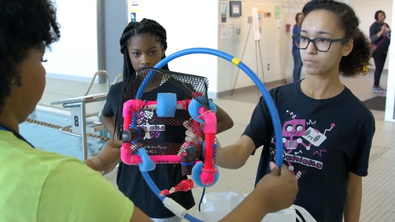 Madison and classmate participating in a STEM robotics activity