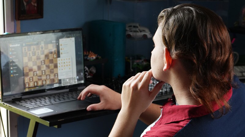 Connections Academy student, Ryan, playing a virtual game of chess on his laptop