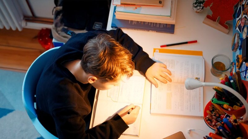 A student at his desk doing schoolwork