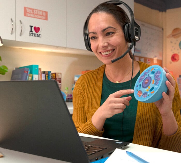 A teacher showing a model of a cell in an online class