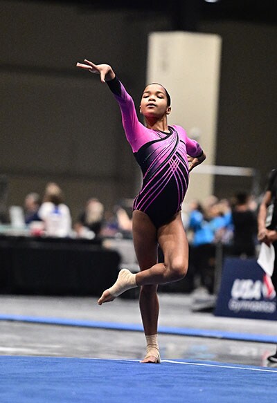 Image of Jaysha M., an Arizona Connections Academy student, performing her floor routine at a gymnastics competition.