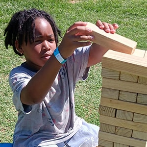 Image of Kelly M from California Connections Academy who is playing a life size version of Jenga. 