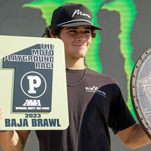 Image of Maddox, a motocross competitor here at a competition showing his 1st place award, he is a student at Colorado Connections Academy. 