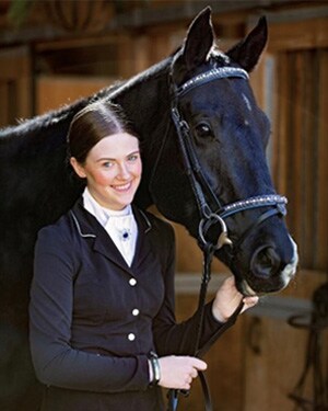 Image of Grace Davis, a senior at Colorado Connections Academy with her black horse. 