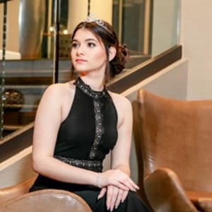 Image of Claudia in a black dress sitting down from Georgia Connections Academy. 