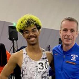 Image of Aaron from Indiana Connections Academy smiling here with his track coach. 