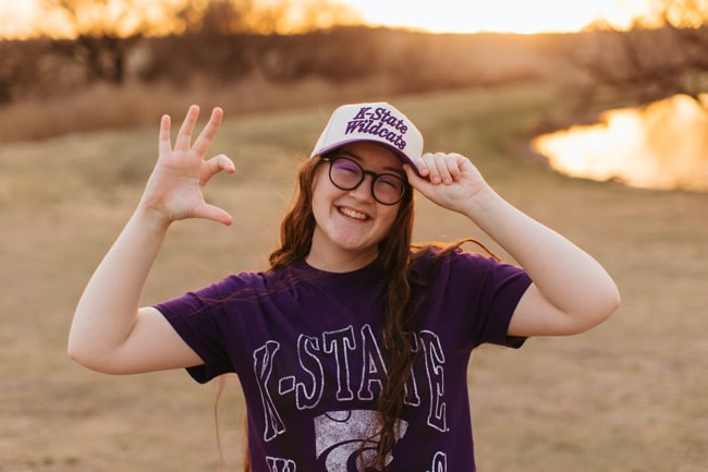 Felicity wearing a Kansas State University tshirt and hat