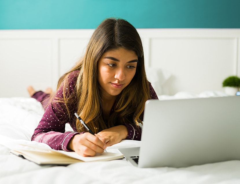 Online high school student taking notes