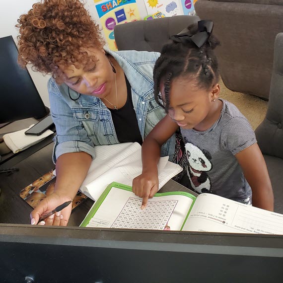A mother is helping her daughter with math homework - Connections Academy