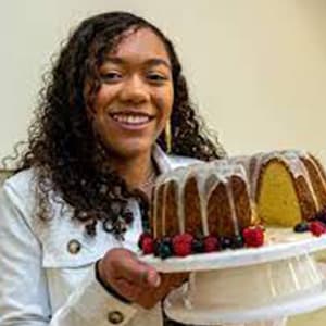 Image of Lilly T, a student at Michigan Connections Academy pictured here holding a bundt cake that she has baked. 