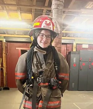 Image of Sadie in her firefighter gear.