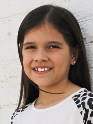 Image of Maja N, a student at Falcon View Connections Academy. She is smiling agaisnt a white wall and is wearing a white shirt.