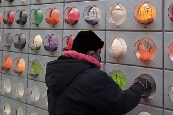 Image of Marley M getting candy out of a candy machine. 