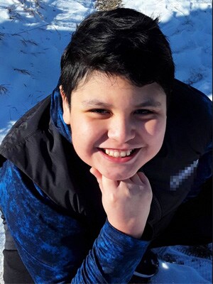 Image of Marley L smiling in a blue shirt and a black vest, a student at Minnesota's Falcon View Connections Academy. 