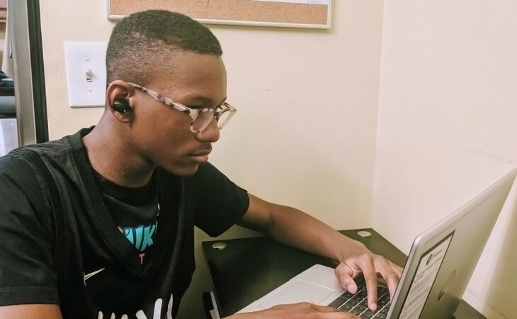 Adrian, a student from Minnesota Connections Academy works at his computer.