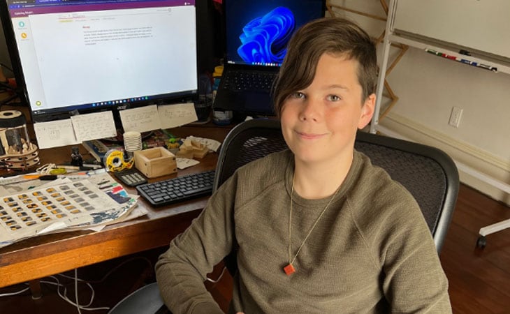 Felix sits at his computer.