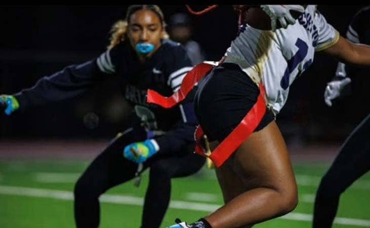 Keiarra from Nevada Connections Academy playing flag football with her teammates. 