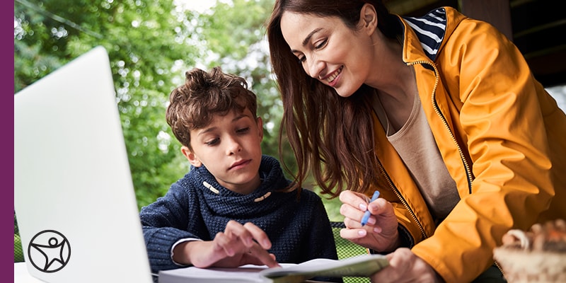 A mother and her son studying outside at Pearson Online Academy