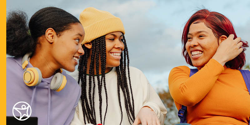 Three students sharing a laugh outside at Connections Academy