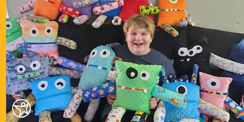 Student surrounded by monster stuffed animals