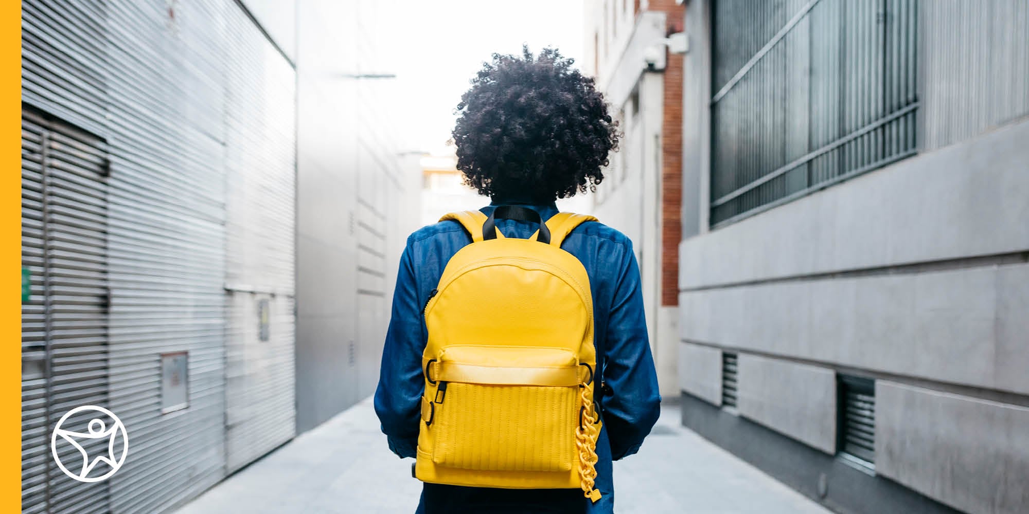 A teenage girl is laying on the floor doing school work