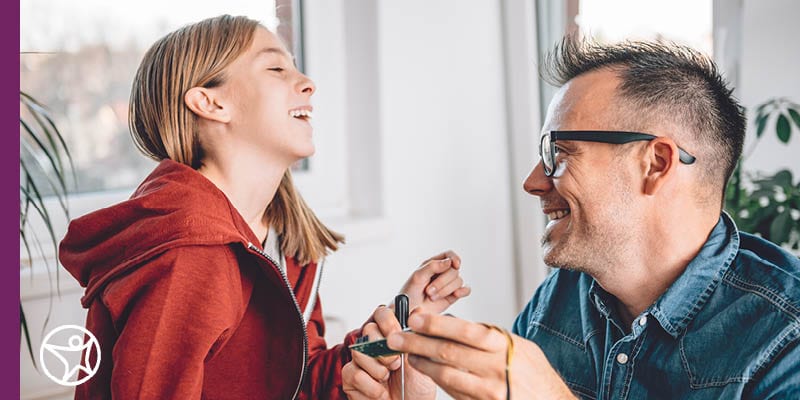 An online school student on the couch wearing headphones taking part in an online lesson