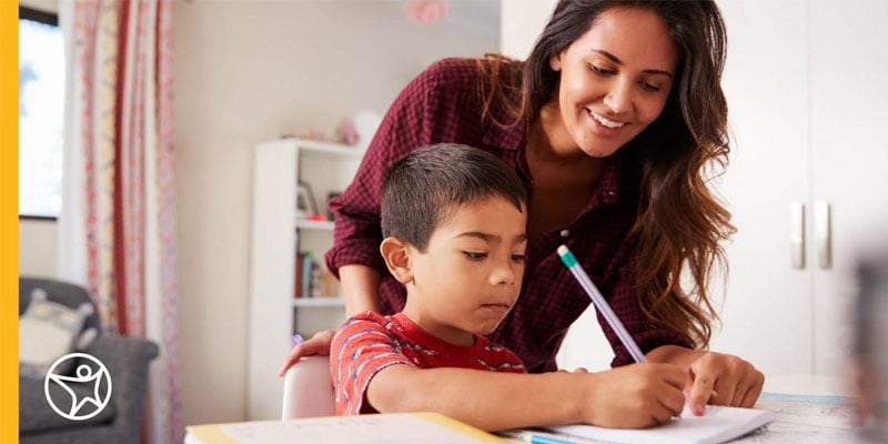 Learning Coach and her son writing in a notebook