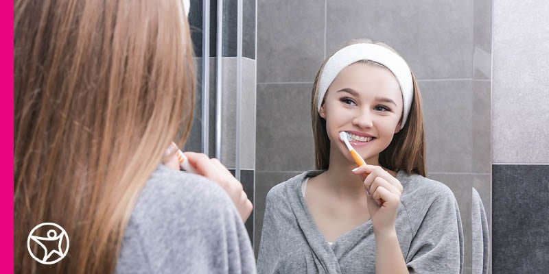 An online school student brushing her teeth