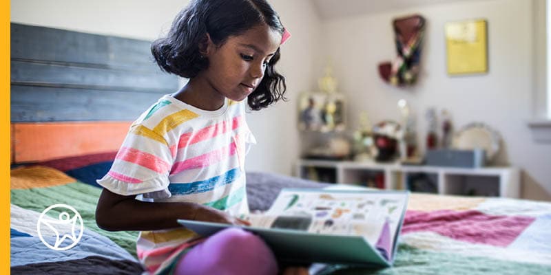 Online school student reading a textbook